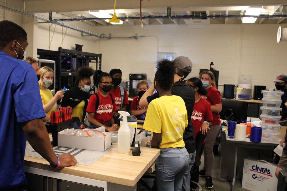 Students listen to a 3D printing explanation